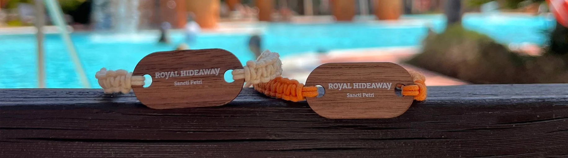 Actual orange woven-cord natural wood RFID wristband manufactured by PrintPlast for Royal Hideaway Sancti Petri