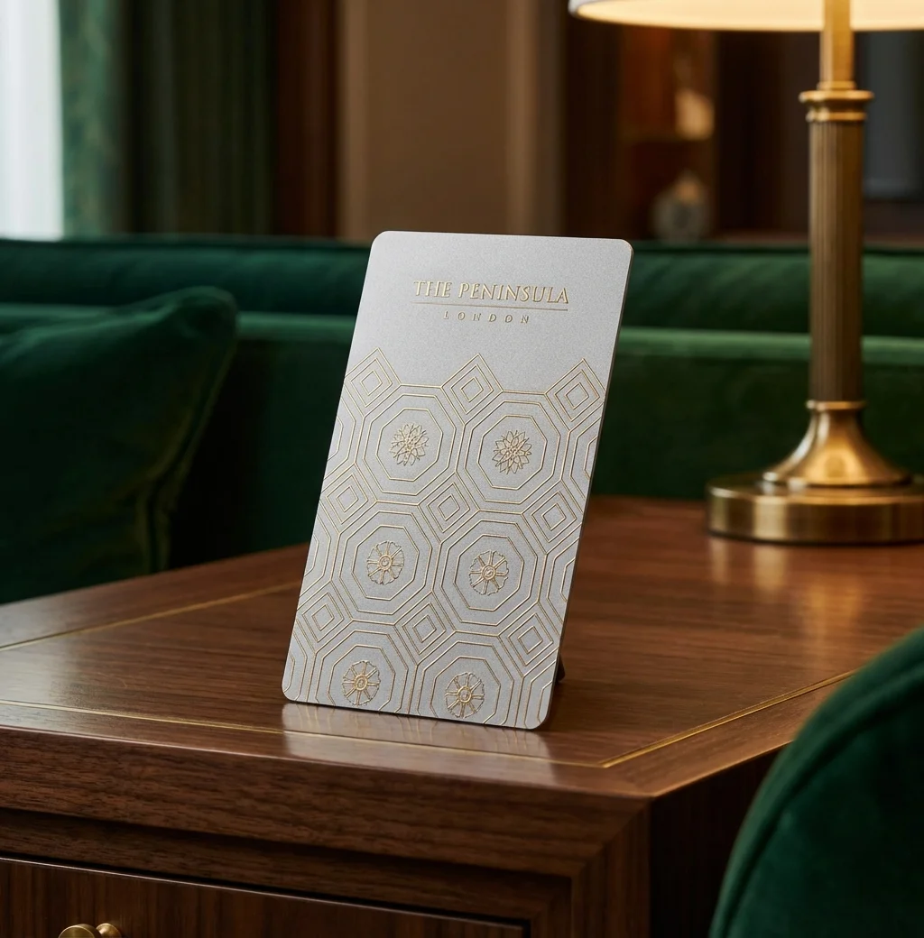 The Peninsula London gouden zeshoekige sleutelkaart op walnootbureau met groen fluweel en messing lamp