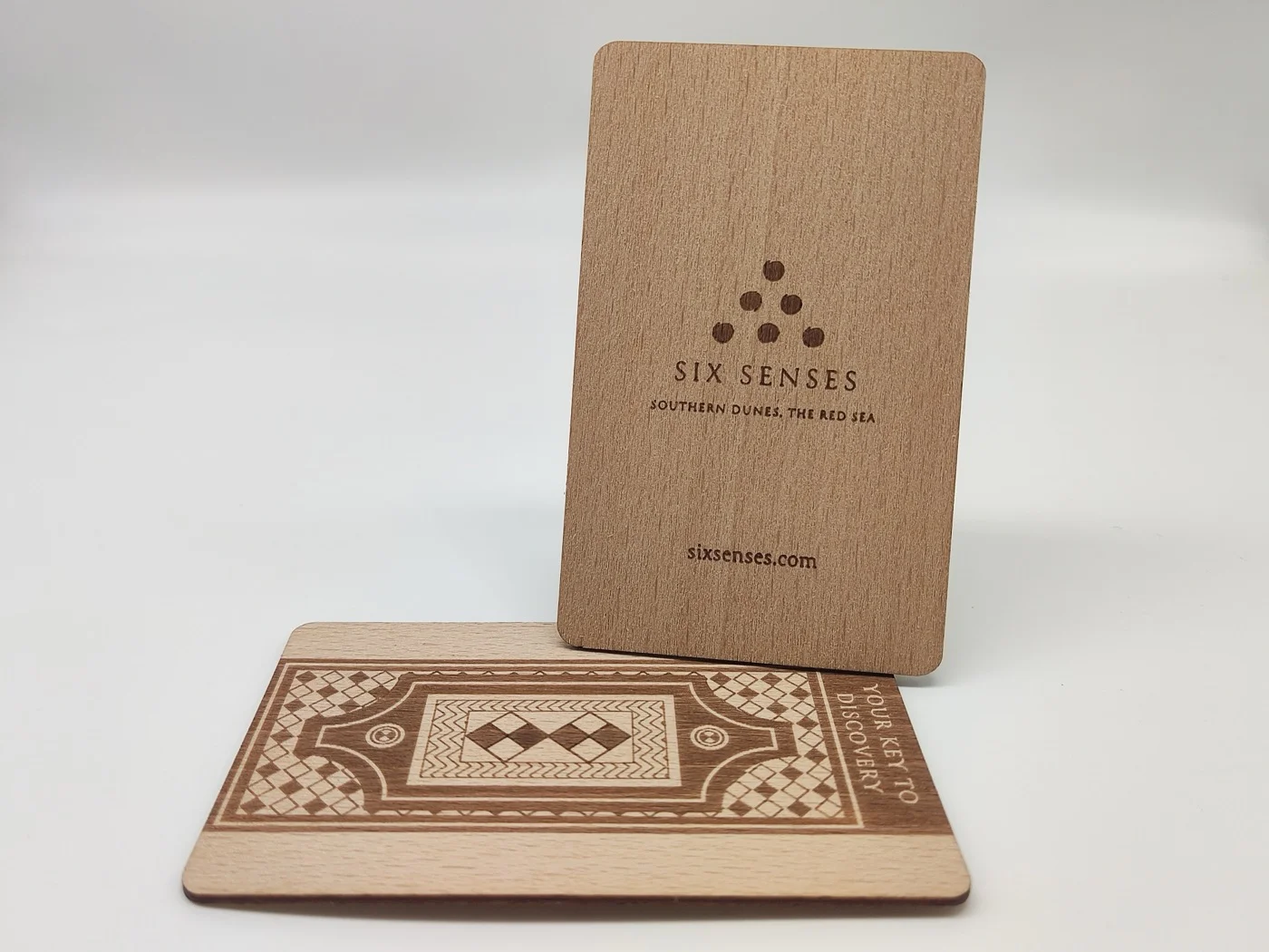 Six Senses Southern Dunes beech wood key card with geometric Arabian pattern laser engraved