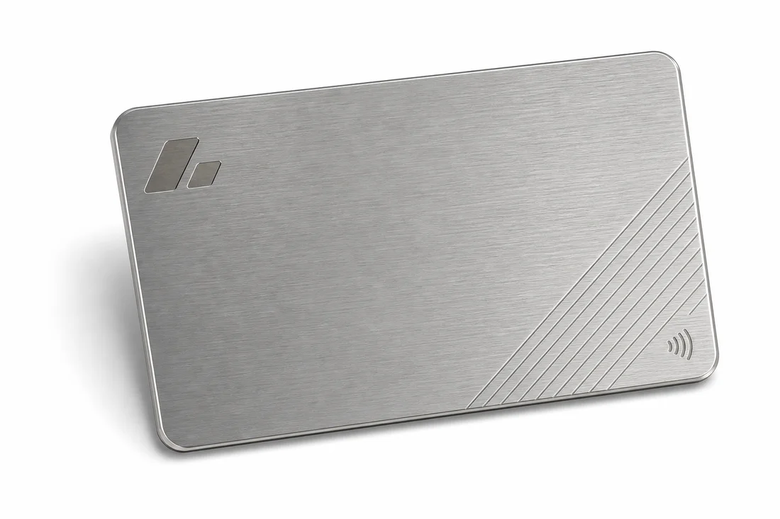 Brushed stainless steel RFID card with laser-etched line detail and a contactless symbol on a white background