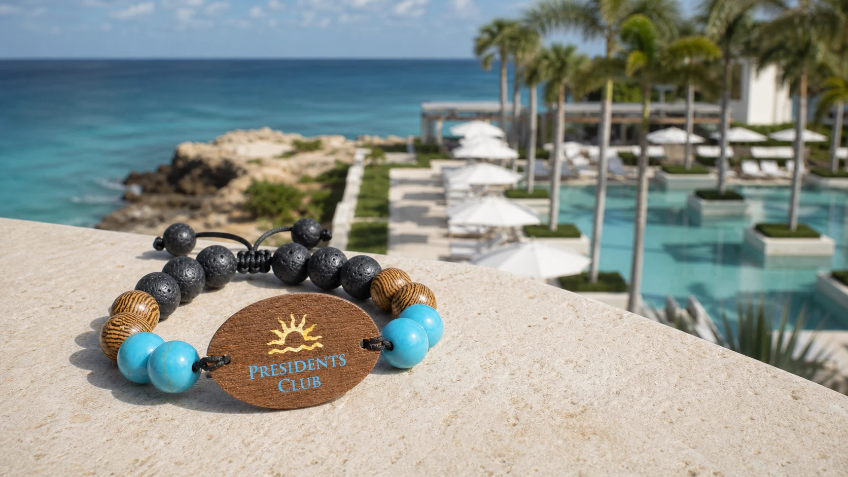 Presidents Club custom RFID event wristband displayed beside a turquoise Anguilla pool