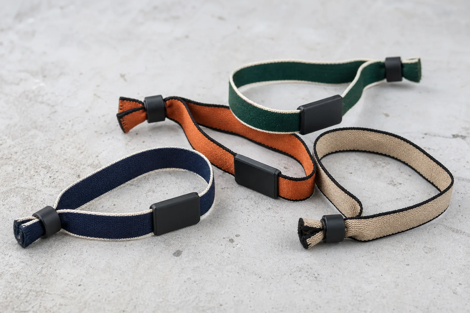 Production visualization of blank woven RFID wristbands in navy, orange, forest and sand