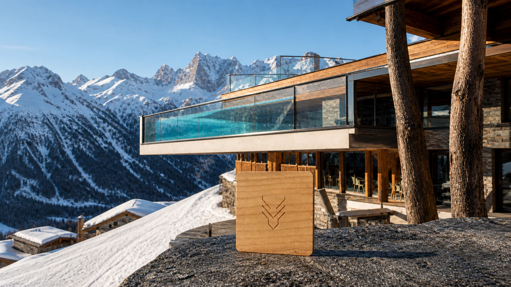 Square cherry-wood RFID room key produced for Hotel Hubertus beside its cantilevered Sky Pool in South Tyrol