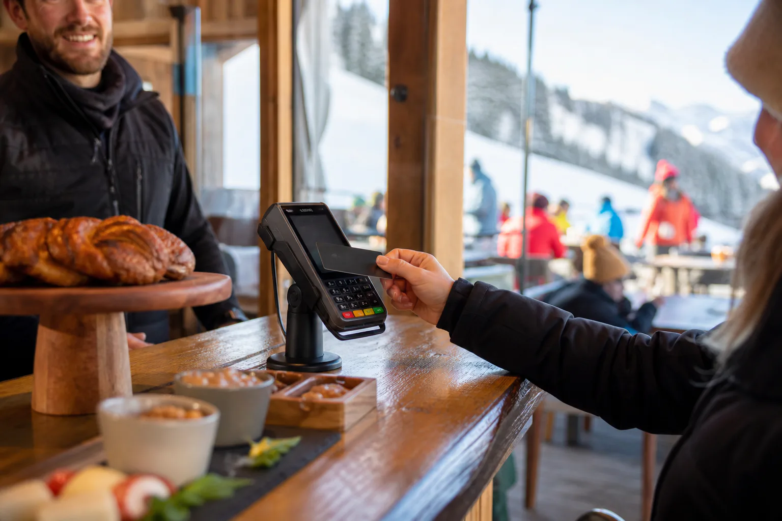 Skier making a cashless restaurant purchase with an RFID resort card