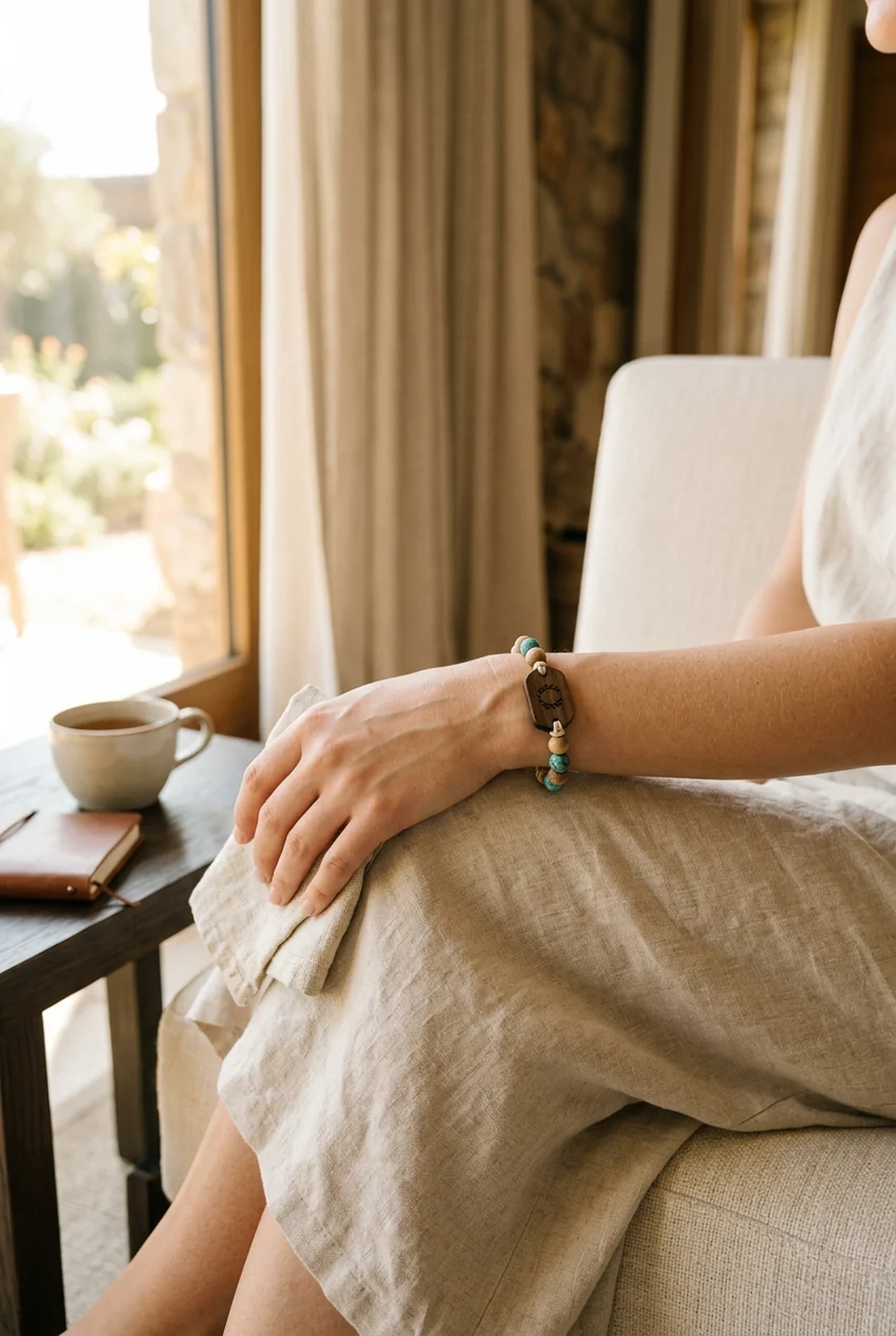 A resort guest in a green dress wearing her engraved PrintPlast bead band on her wrist.
